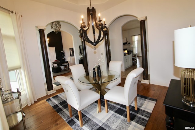 1964 Chestnut Ln, Washington, IL 61571 - dining area featuring arched walkways, ornate columns, hardwood / wood-style floors, and a chandelier