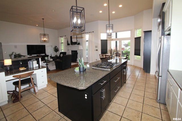 1964 Chestnut Ln, Washington, IL 61571 - kitchen featuring appliances with stainless steel finishes, white cabinets, dark cabinetry, open floor plan, and a kitchen island