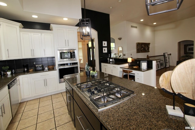 1964 Chestnut Ln, Washington, IL 61571 - kitchen with stainless steel appliances, recessed lighting, white cabinetry, tasteful backsplash, and dark stone counters