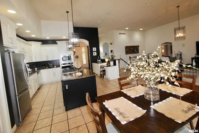 1964 Chestnut Ln, Washington, IL 61571 - dining space featuring a chandelier, arched walkways, light tile patterned floors, and recessed lighting