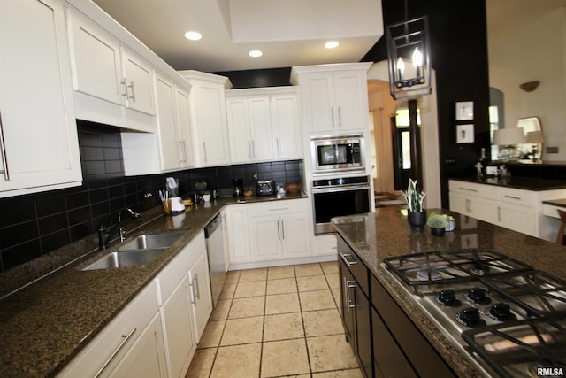 1964 Chestnut Ln, Washington, IL 61571 - kitchen with appliances with stainless steel finishes, backsplash, white cabinetry, recessed lighting, and dark stone countertops