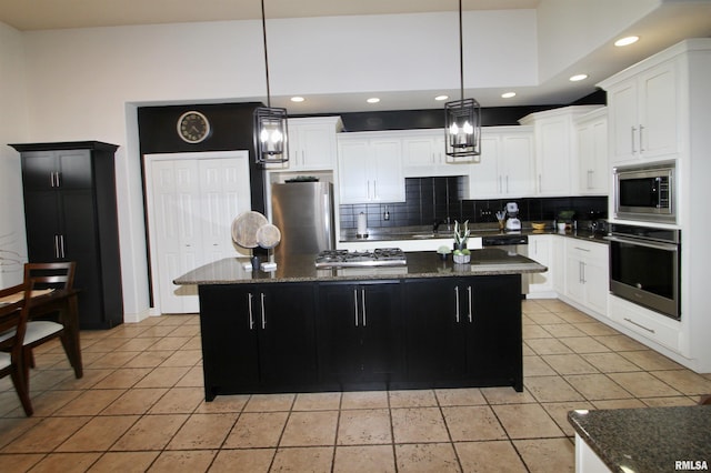 1964 Chestnut Ln, Washington, IL 61571 - kitchen featuring appliances with stainless steel finishes, backsplash, dark stone counters, recessed lighting, and light tile patterned floors