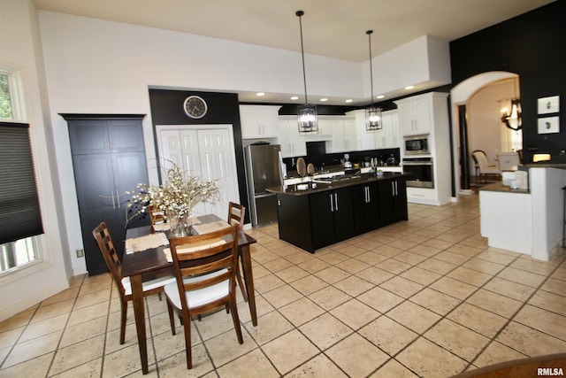 1964 Chestnut Ln, Washington, IL 61571 - kitchen with appliances with stainless steel finishes, dark countertops, a center island with sink, backsplash, and decorative light fixtures