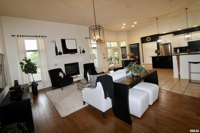 1964 Chestnut Ln, Washington, IL 61571 - living area featuring a glass covered fireplace, healthy amount of natural light, recessed lighting, dark wood-style flooring, and a chandelier
