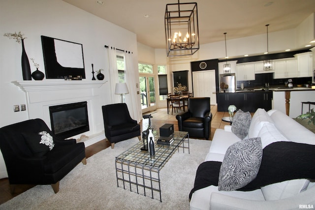 1964 Chestnut Ln, Washington, IL 61571 - living room featuring a glass covered fireplace, a chandelier, and recessed lighting