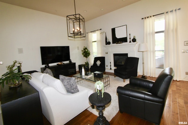 1964 Chestnut Ln, Washington, IL 61571 - living area with wood finished floors, a chandelier, and a glass covered fireplace