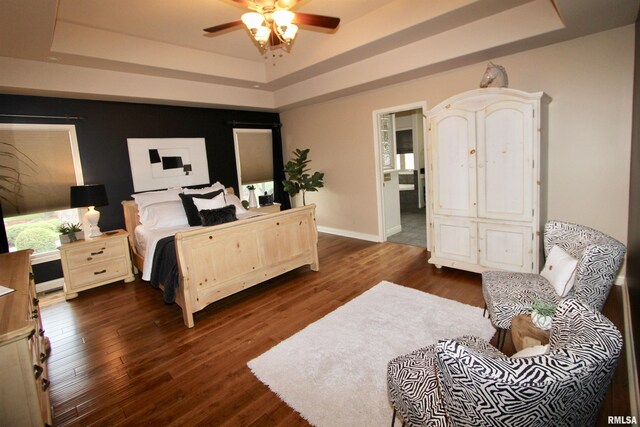 1964 Chestnut Ln, Washington, IL 61571 - bedroom with a tray ceiling, dark wood-style flooring, and ceiling fan