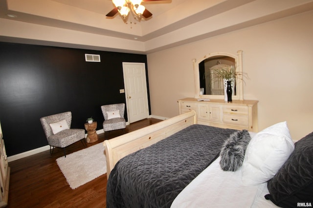 1964 Chestnut Ln, Washington, IL 61571 - bedroom featuring dark wood-style floors, ceiling fan, and a tray ceiling
