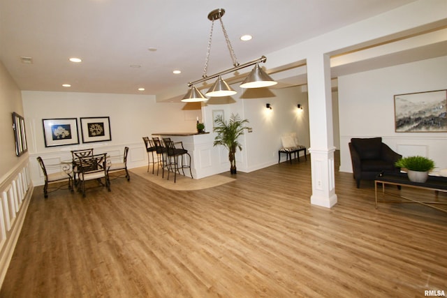 1964 Chestnut Ln, Washington, IL 61571 - living area with light wood-style floors, recessed lighting, a decorative wall, decorative columns, and a wainscoted wall