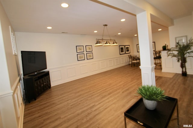 1964 Chestnut Ln, Washington, IL 61571 - living room featuring wood finished floors, recessed lighting, a decorative wall, and wainscoting