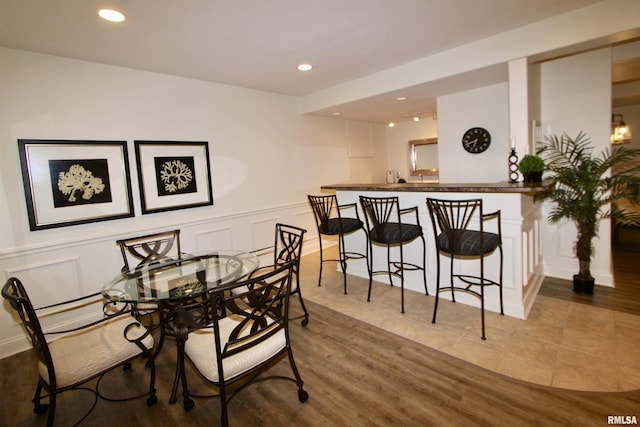 1964 Chestnut Ln, Washington, IL 61571 - dining space featuring a decorative wall, recessed lighting, a wainscoted wall, and wood finished floors