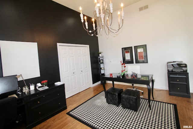 1964 Chestnut Ln, Washington, IL 61571 - home office with a chandelier, wood finished floors, and a towering ceiling