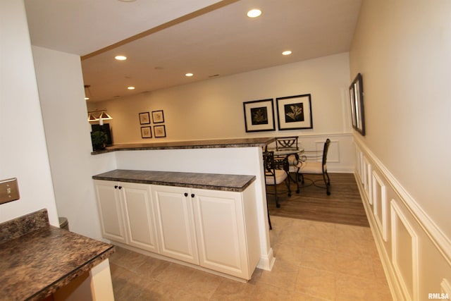 1964 Chestnut Ln, Washington, IL 61571 - kitchen featuring dark countertops, recessed lighting, a peninsula, white cabinetry, and a wainscoted wall