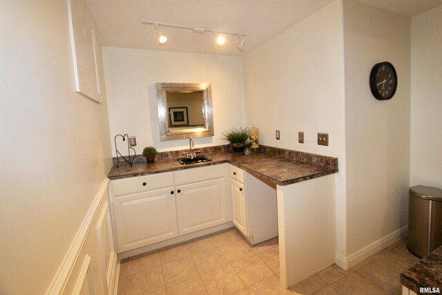 1964 Chestnut Ln, Washington, IL 61571 - kitchen featuring dark countertops, rail lighting, white cabinetry, and light tile patterned flooring