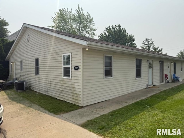 102 Main St, Camp Grove, IL 61424 - view of home's exterior with cooling unit and a lawn
