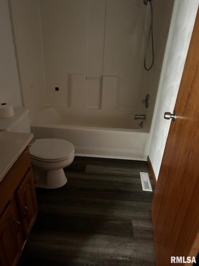 102 Main St, Camp Grove, IL 61424 - full bath with vanity, wood finished floors, toilet, and tub / shower combination