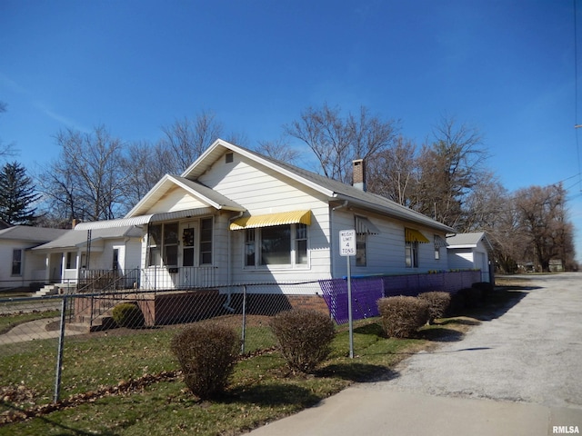 120 W Adams St, Macomb, IL 61455 - view of front of property with a chimney and a fenced front yard