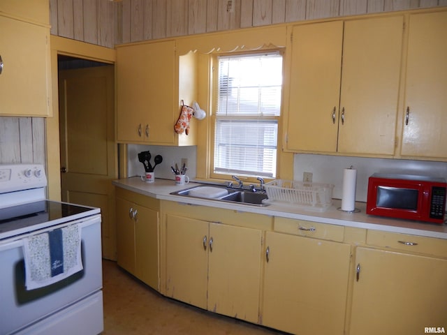 120 W Adams St, Macomb, IL 61455 - kitchen with electric range, a sink, light countertops, and cream cabinets