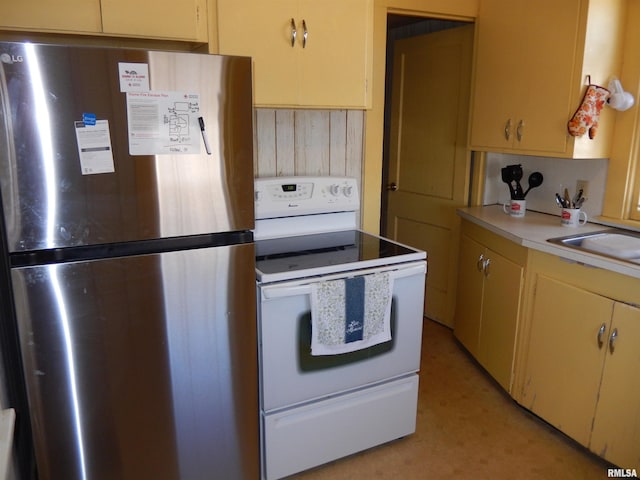 120 W Adams St, Macomb, IL 61455 - kitchen with freestanding refrigerator, white range with electric stovetop, light countertops, and a sink