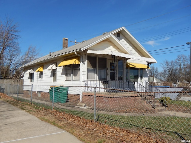 120 W Adams St, Macomb, IL 61455 - bungalow featuring a chimney and a fenced front yard
