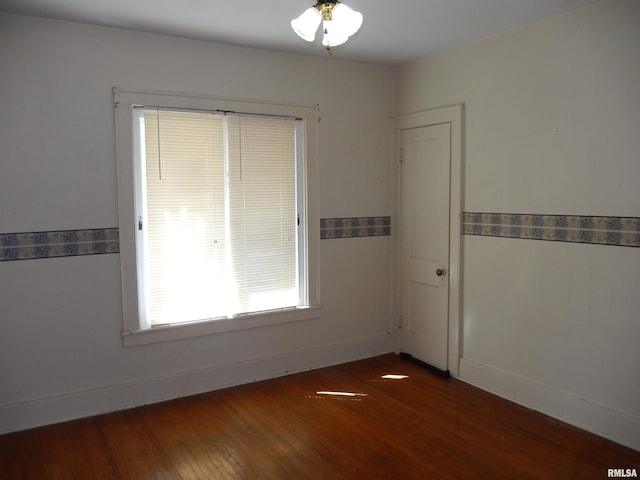 120 W Adams St, Macomb, IL 61455 - unfurnished room with dark wood-style flooring and baseboards