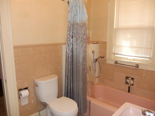 120 W Adams St, Macomb, IL 61455 - bathroom featuring tile walls, toilet, a wainscoted wall, and shower / bathtub combination with curtain