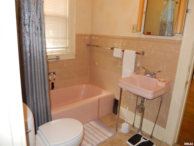 120 W Adams St, Macomb, IL 61455 - full bath featuring a bath, toilet, a sink, tile patterned floors, and tile walls