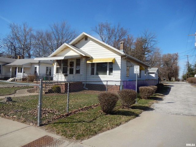 120 W Adams St, Macomb, IL 61455 - view of front of house featuring a fenced front yard and a chimney