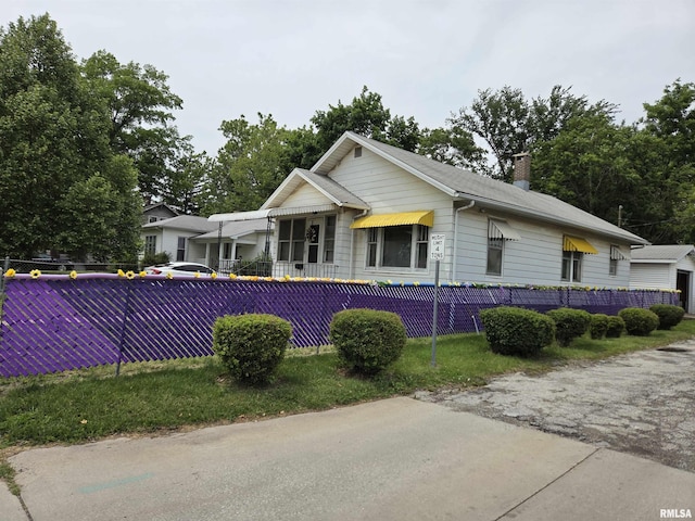 120 W Adams St, Macomb, IL 61455 - view of front of property with a fenced front yard and a chimney
