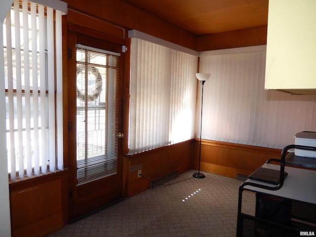 120 W Adams St, Macomb, IL 61455 - unfurnished dining area featuring healthy amount of natural light, baseboard heating, and carpet floors