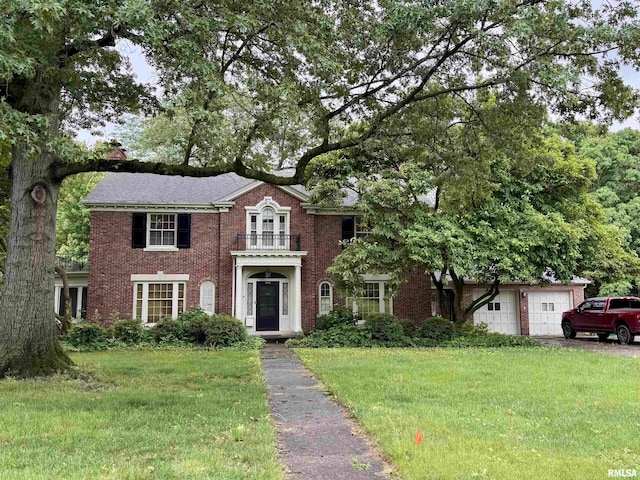 360 N Normal St, Macomb, IL 61455 - colonial inspired home featuring a front yard, brick siding, and a garage