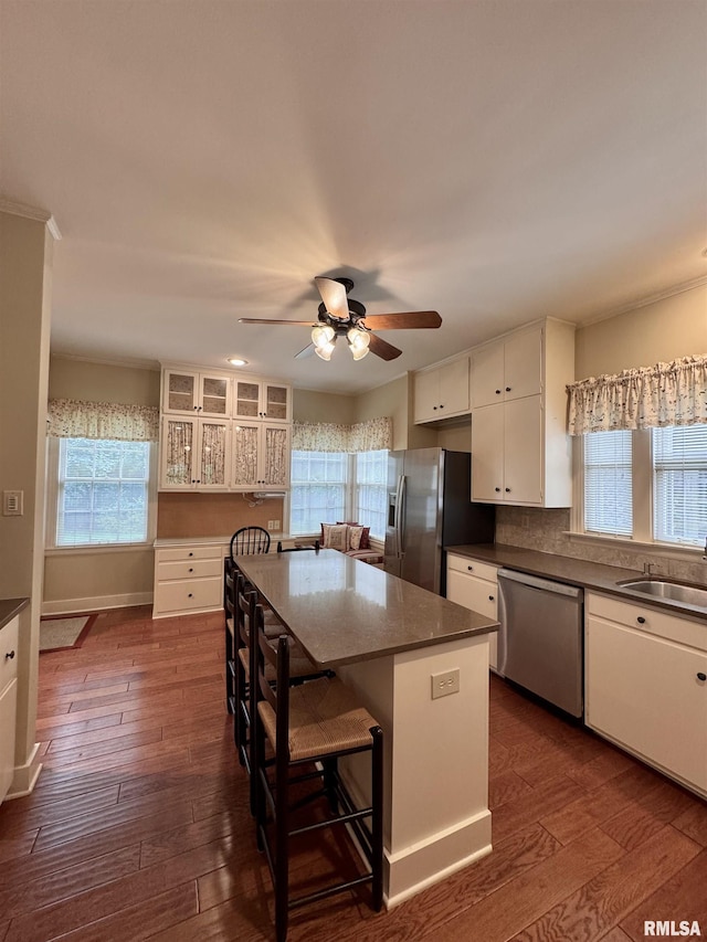 360 N Normal St, Macomb, IL 61455 - kitchen with stainless steel appliances, white cabinetry, dark wood finished floors, and plenty of natural light