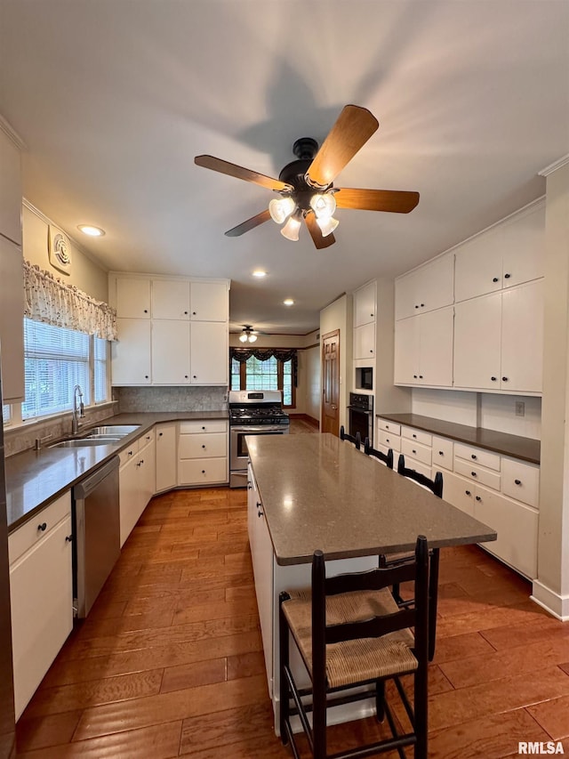 360 N Normal St, Macomb, IL 61455 - kitchen featuring stainless steel appliances, dark countertops, healthy amount of natural light, and recessed lighting