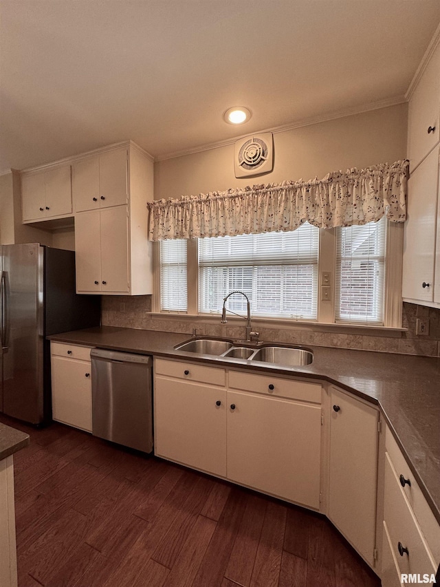 360 N Normal St, Macomb, IL 61455 - kitchen with appliances with stainless steel finishes, white cabinets, crown molding, dark wood-style flooring, and healthy amount of natural light
