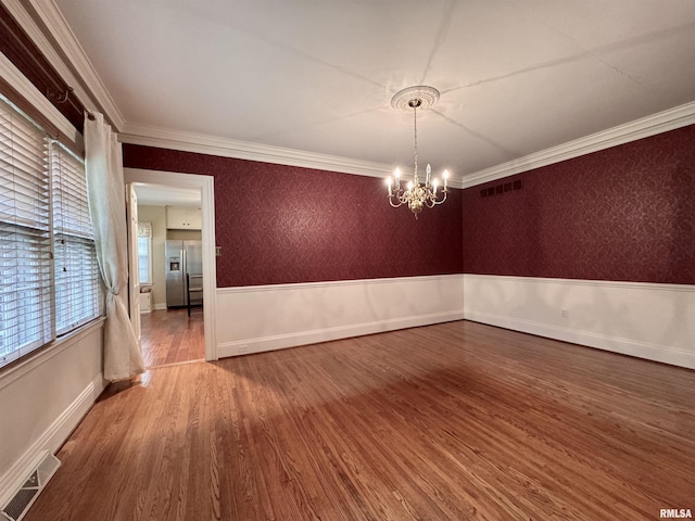 360 N Normal St, Macomb, IL 61455 - spare room with wood finished floors, a chandelier, and ornamental molding