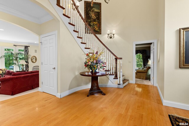 11518 N Nettle Creek Dr, Dunlap, IL 61525 - foyer with wood finished floors, arched walkways, stairs, ornamental molding, and a high ceiling