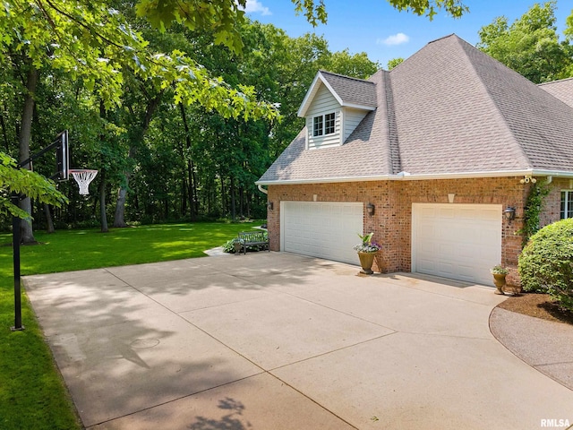 11518 N Nettle Creek Dr, Dunlap, IL 61525 - view of side of property with brick siding, a yard, concrete driveway, and a shingled roof