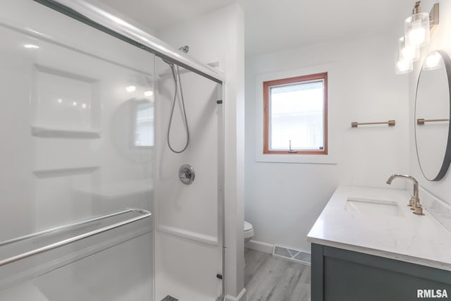 4415 N Rosemead Dr, Peoria, IL 61614 - bathroom featuring vanity, a shower stall, and wood finished floors
