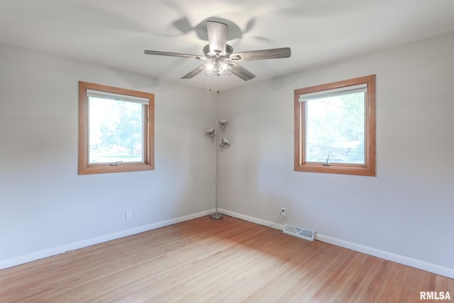 4415 N Rosemead Dr, Peoria, IL 61614 - unfurnished room featuring plenty of natural light, light wood-style flooring, and a ceiling fan