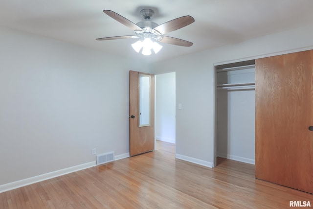 4415 N Rosemead Dr, Peoria, IL 61614 - unfurnished bedroom featuring a closet, light wood-style floors, and a ceiling fan
