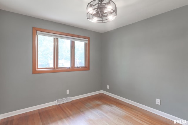 4415 N Rosemead Dr, Peoria, IL 61614 - empty room with a chandelier and light wood finished floors