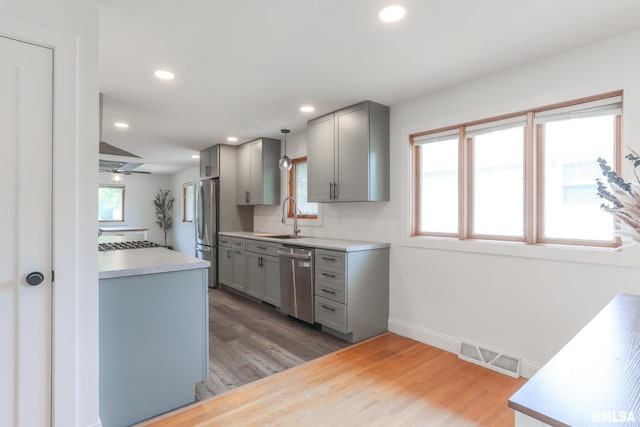 4415 N Rosemead Dr, Peoria, IL 61614 - kitchen featuring stainless steel appliances, gray cabinetry, light wood finished floors, and recessed lighting