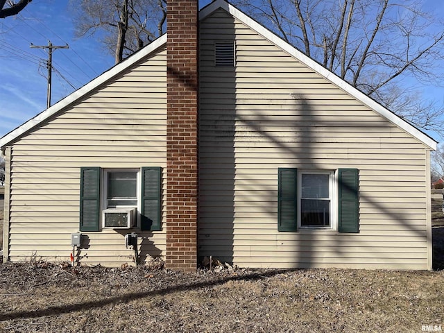 665 W Wilmot St, Chillicothe, IL 61523 - view of home's exterior with a chimney and cooling unit