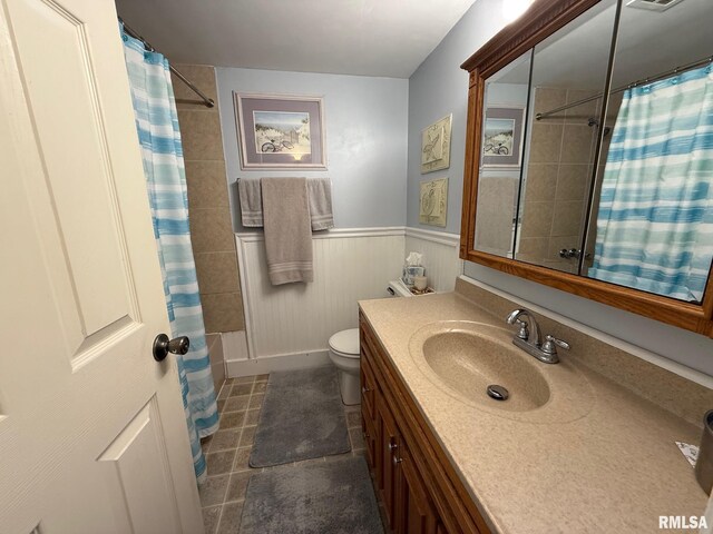 603 Sherry St, Colchester, IL 62326 - bathroom with vanity, a wainscoted wall, toilet, and curtained shower