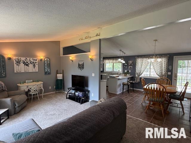 603 Sherry St, Colchester, IL 62326 - living area with a chandelier, a textured ceiling, and dark tile patterned floors