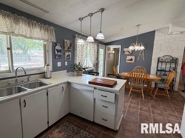 603 Sherry St, Colchester, IL 62326 - kitchen featuring white dishwasher, a sink, lofted ceiling, light countertops, and white cabinetry