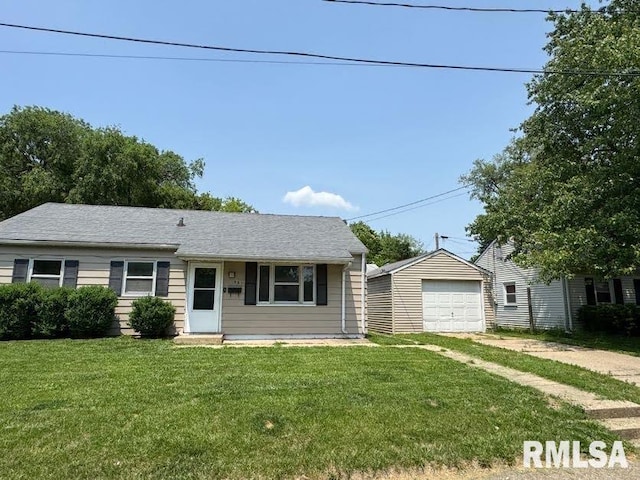 831 W Bartlett Ct, Peoria, IL 61604 - view of front of house with a front lawn, a detached garage, driveway, and an outbuilding