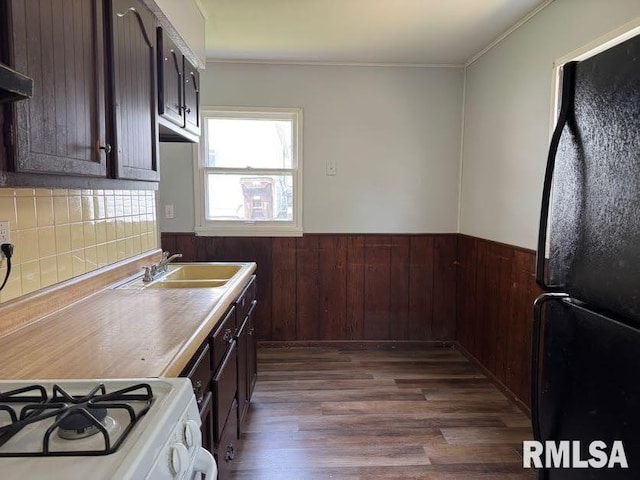 831 W Bartlett Ct, Peoria, IL 61604 - kitchen with freestanding refrigerator, a sink, white range with gas cooktop, dark wood-style floors, and wainscoting