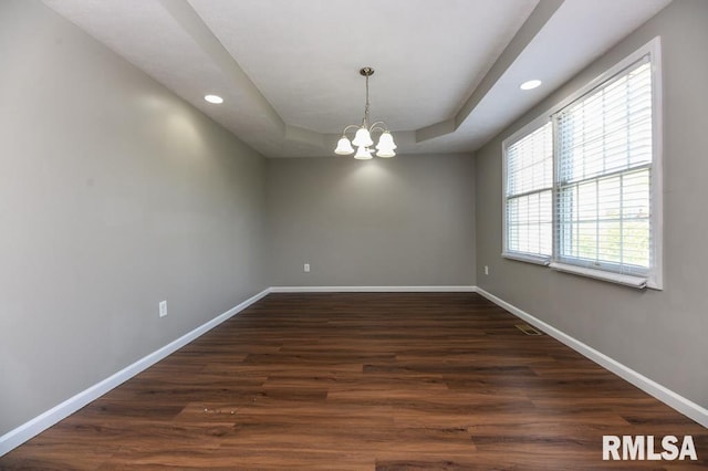 2331 W Molly Ln, Dunlap, IL 61525 - spare room with a raised ceiling, baseboards, a chandelier, recessed lighting, and dark wood-type flooring