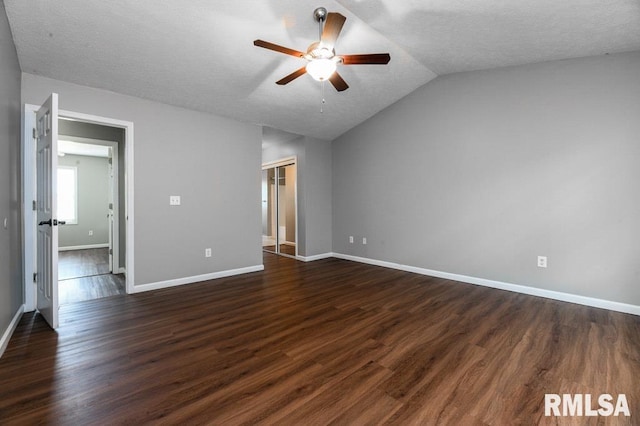 2331 W Molly Ln, Dunlap, IL 61525 - unfurnished bedroom featuring vaulted ceiling, baseboards, dark wood-style flooring, a ceiling fan, and a textured ceiling